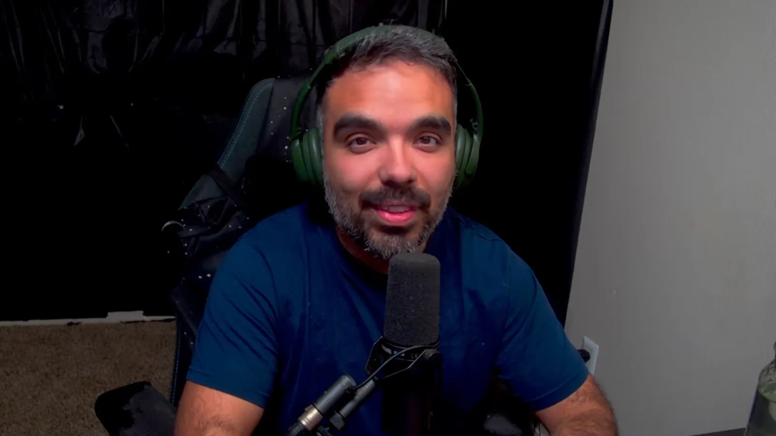 AniimoSync on camera at his microphone, closing his Aniimo October Dev Feedback video by saying player feedback is being heard