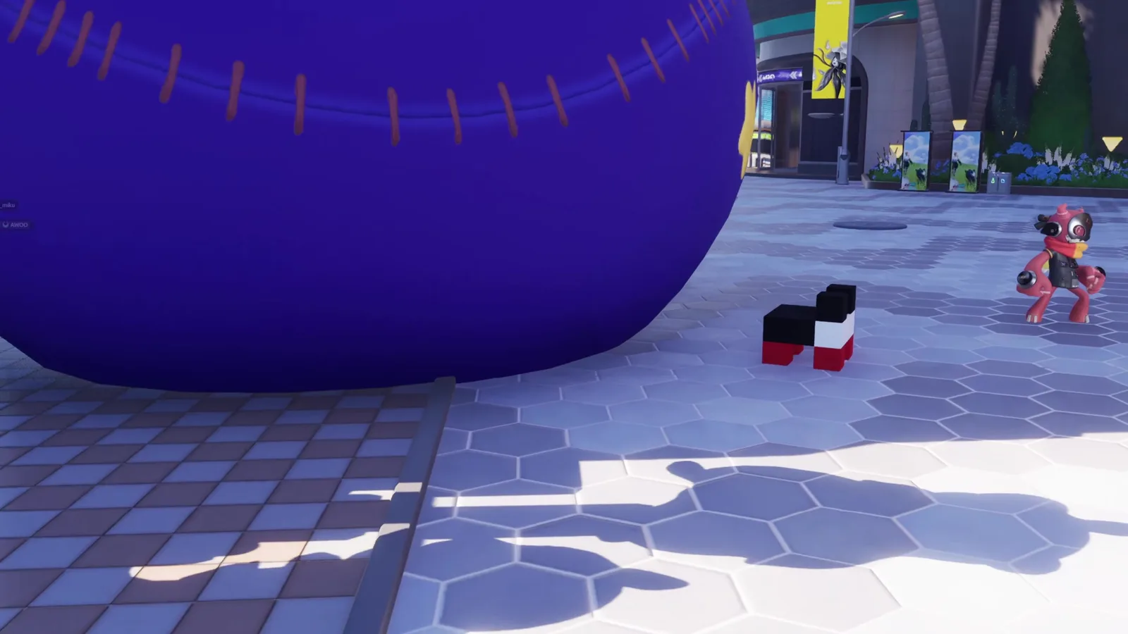 Aniimo cubic Voxel figure made of black, white and red blocks next to a red Besauce, in front of the star-covered purple ball in Astra