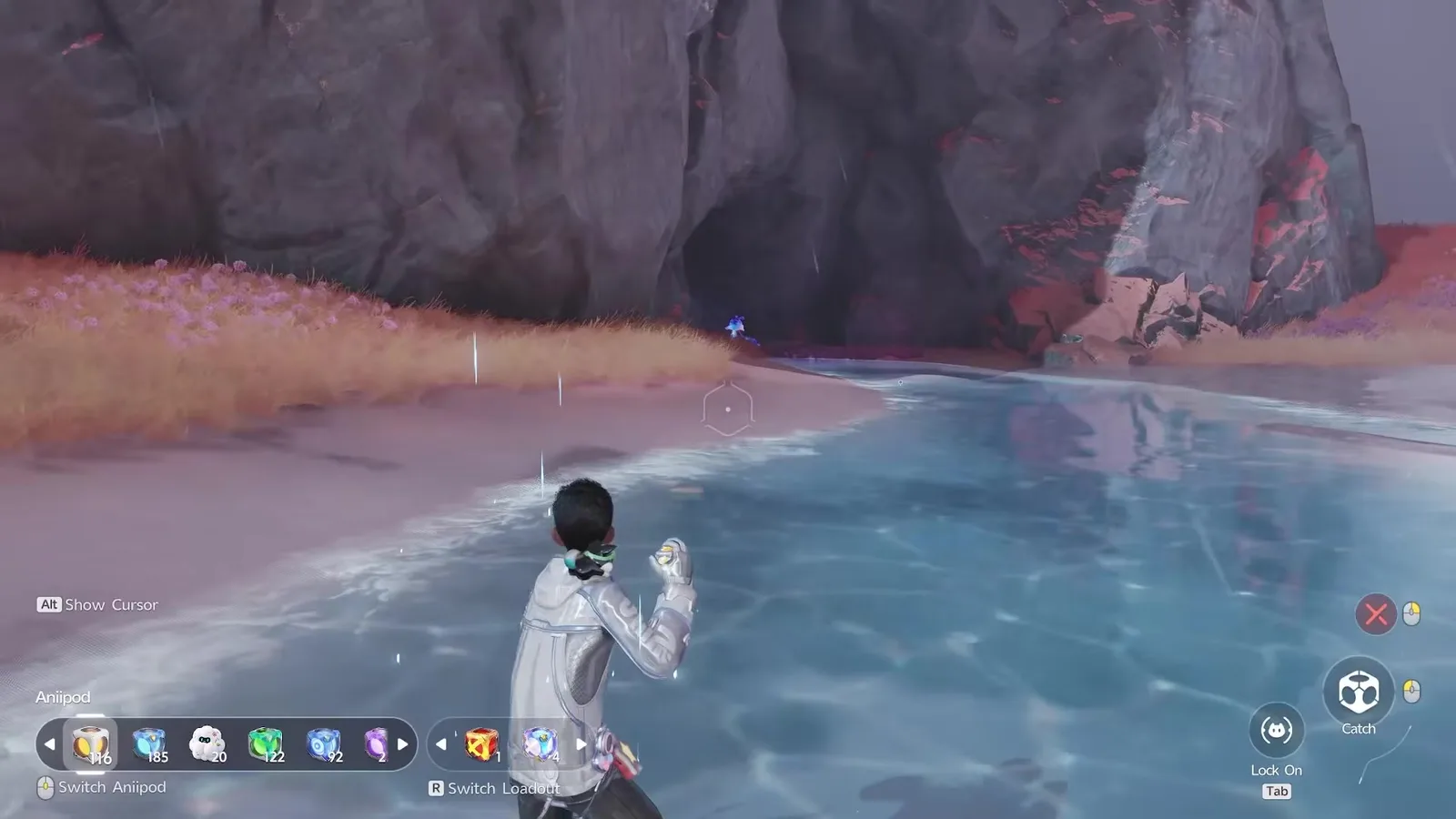 The Aniimo Pathfinder wading up the shallow channel on the right of the cave mouth in Tideblossom Coast, with the blue glow of Rainstorm Luminelle just inside the arch and rain falling